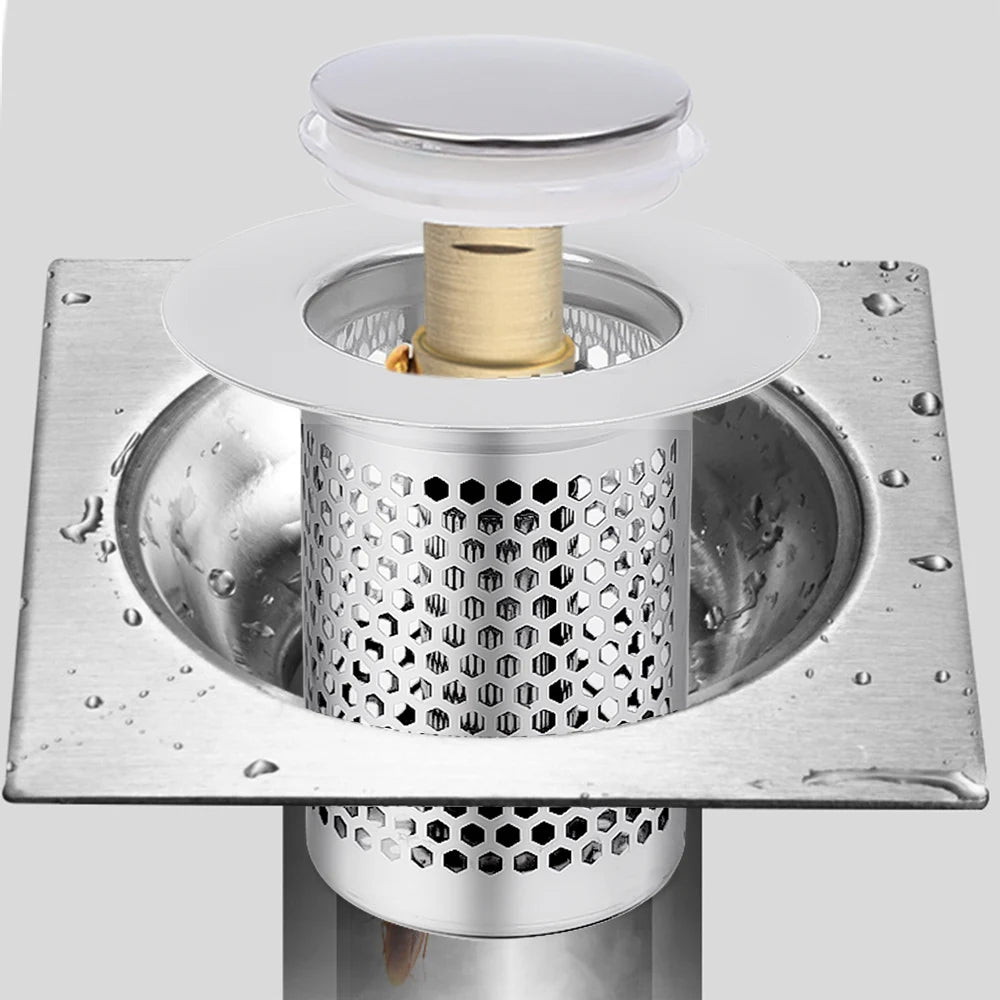 Metallic drain cover with hexagonal pattern on a white background